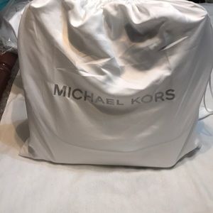 White Michael Kors purse with purse scarf.